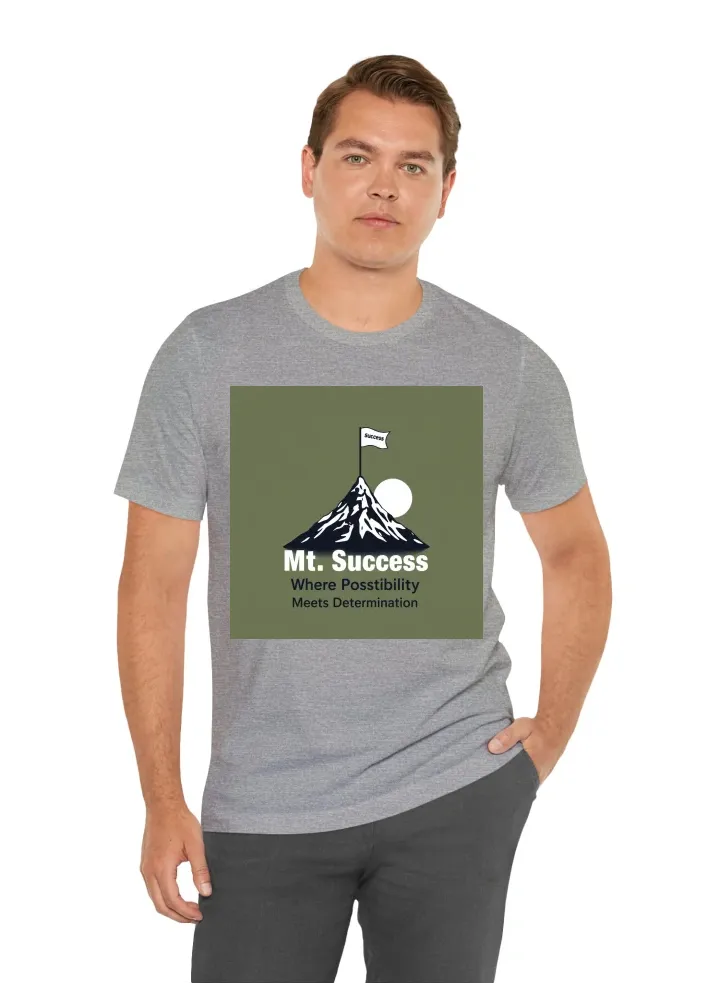 I want a t shirt with a graphic of a man climbing a mountain. The mountain should have a flag on top of it, that says "Mt. Success". Under the graphic, the quote "Where Possibility Meets Determination" should be written.