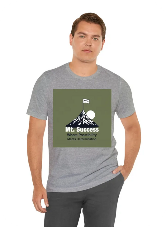 I want a t shirt with a graphic of a man climbing a mountain. The mountain should have a flag on top of it, that says "Mt. Success". Under the graphic, the quote "Where Possibility Meets Determination" should be written.