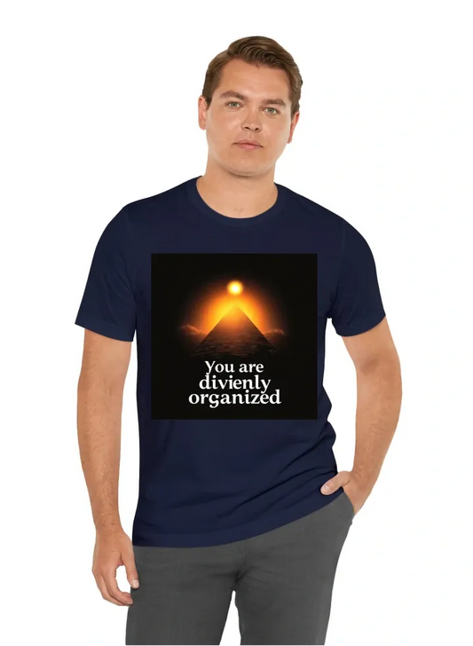 Pyramid with a small sun over it. a text that makes you see the pyramid through it, saying " you are divinely organized". the text should fill the whole t-shirt. create a feeling of space, and interconnectedness.